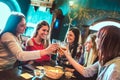 Happy girlfriends toasting beer at brewery bar restaurant - Female friendship concept with young women having genuine fun together