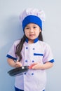 Happy girls with amazing smile in clothes and chef cap. child dreams of becoming a chef