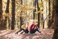 Happy girls with cell phone on autumn park. Friendship womens concept, smiling female friends with smartphones.