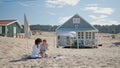 Happy girls checking social media smartphone at beach houses. Two friends rest Royalty Free Stock Photo