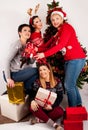 Festive Delight: Four Joyful Girls Celebrating Christmas with Gift Boxes and Decorations Royalty Free Stock Photo