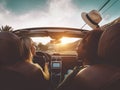 Happy girls doing road trip in tropical city - Travel people having fun driving in trendy convertible car discovering new places