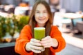 happy girls drinking green healthy dietary nutritious cocktail. focus on hands with glass Royalty Free Stock Photo