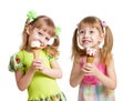 Happy girls eat ice cream in studio isolated