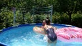 Happy girls have fun chilling and floating on donut floats in swimming pool in summer, floatation