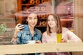 Happy girls having lunch in a cafe, drinking coffe and talking. Friendship and lifestyle concept Royalty Free Stock Photo