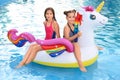 Happy girls on inflatable  in swimming pool Royalty Free Stock Photo