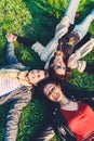 Happy girls lying head to head on green grass Royalty Free Stock Photo