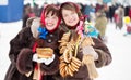 Happy girls with pancake during Shrovetide