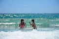 Happy girls playing in beautiful ocean. Royalty Free Stock Photo