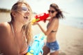 Happy girls playing with water gun.Travel on vacation at sea Royalty Free Stock Photo