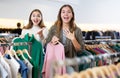 Happy girls pointing finger at new clothes in clothing store Royalty Free Stock Photo