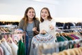 Happy girls pointing finger at new clothes in clothing store Royalty Free Stock Photo