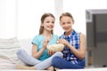 Happy girls with popcorn watching tv at home Royalty Free Stock Photo