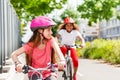 Happy girls riding bikes during summer vacation Royalty Free Stock Photo