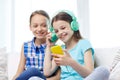 Happy girls with smartphone and headphones Royalty Free Stock Photo