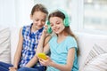 Happy girls with smartphone and headphones Royalty Free Stock Photo