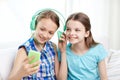 Happy girls with smartphone and headphones Royalty Free Stock Photo