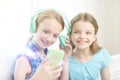 Happy girls with smartphone and headphones Royalty Free Stock Photo