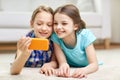 Happy girls with smartphone taking selfie at home Royalty Free Stock Photo