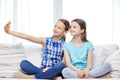 Happy girls with smartphone taking selfie at home Royalty Free Stock Photo