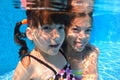 Happy girls swim underwater in pool Royalty Free Stock Photo