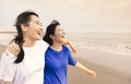 Happy girls walking and playing together on tropical beach at summer sunset Royalty Free Stock Photo