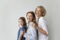 Happy girls and women of three generations posing at white Royalty Free Stock Photo