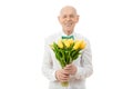 Happy, glad, cheerful, joyful smiling old man in white shirt, senior holds bouquet of yellow flowers in hands and