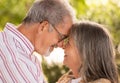 Happy glad european mature man and woman hugging, want kissing, enjoy date together in park at summer