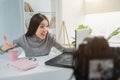 Happy and glad girl is looking to the laptop`s screen. Se is talking with somebody using internet connection for that Royalty Free Stock Photo