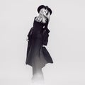 Happy Glamorous lady in a black coat and hat. Black and white vi Royalty Free Stock Photo