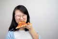 Happy glasses Asian young woman eat Pizza on white background