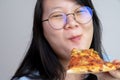 Happy glasses Asian young woman eat Pizza on white background