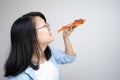 Happy glasses Asian young woman eat Pizza on white background
