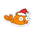 happy goldfish hand drawn sticker cartoon of a wearing santa hat