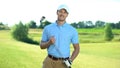 Happy golf player with club smiling on camera, luxury hobby and sport, activity