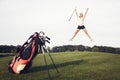 Happy golf player jumping on golf course. Royalty Free Stock Photo