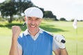 Happy golfer cheering at camera on putting green Royalty Free Stock Photo