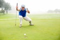 Happy golfer cheering on putting green Royalty Free Stock Photo