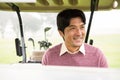 Happy golfer driving his golf buggy Royalty Free Stock Photo