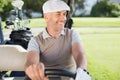 Happy golfer driving his golf buggy Royalty Free Stock Photo