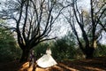 Happy gorgeous bride and stylish groom holding hands and walking Royalty Free Stock Photo