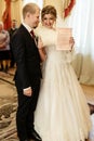 Happy gorgeous bride and stylish groom holding official document Royalty Free Stock Photo