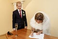 Happy gorgeous bride and stylish groom signing official document Royalty Free Stock Photo