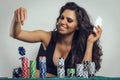 Happy gorgeous girl playing poker, throwing chips