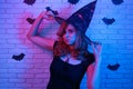 Happy gothic young woman in witch halloween costume partying in Royalty Free Stock Photo