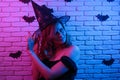 Happy gothic young woman in witch halloween costume partying in Royalty Free Stock Photo