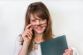 Happy graduate woman with her dissertation work on white Royalty Free Stock Photo