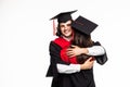 Happy graduated young students couple hugging isolated on white background Royalty Free Stock Photo